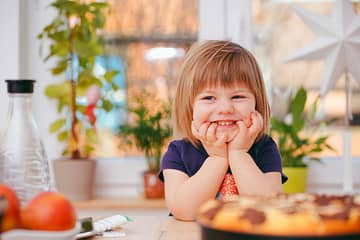 Playful looking child looking at the camera with excitement to create educational toys