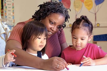 Mom playing with children and their educational toys for small children